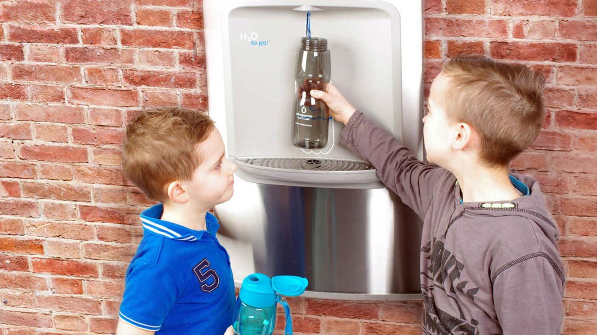 Kids Using an Outdoor H2O-to-Go!® Water Bottle Filler, Wall-Mounted, with Slim Profile